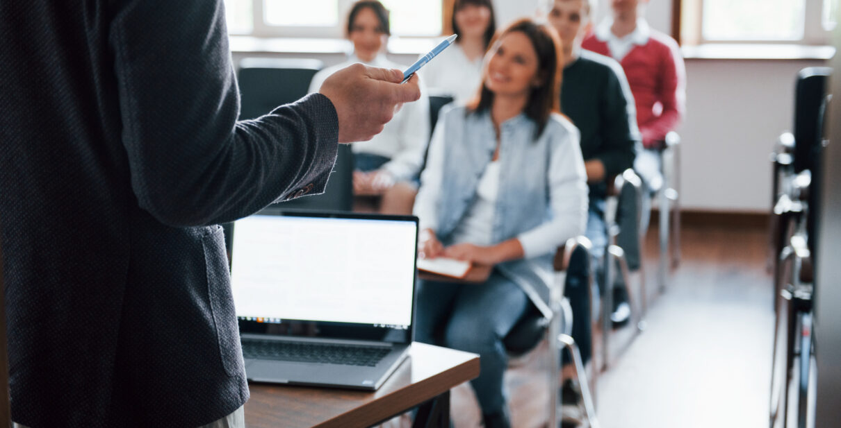 everyone is smiling listens group people business conference modern classroom daytime